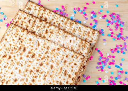 Matzah e confetti sono felici sfondo colorato per la festa della Pasqua Ebraica. Concetto di celebrazione di Pesach. Foto Stock