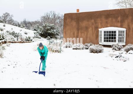 Ragazza teenage di tredici anni che costruisce un pupazzo di neve Foto Stock