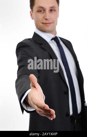 Imprenditore che si estende la mano per agitare Foto Stock