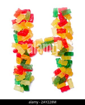 Lettera H dell'alfabeto inglese da una marmellata da masticare multicolore su sfondo bianco isolato. Modello di cibo fatto ffrom bambini dolci orsi Foto Stock