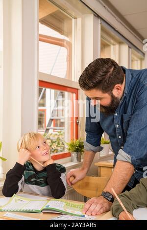 Insegnante con ragazzo in classe Foto Stock