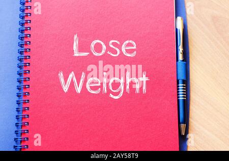 Perdere peso scrivere su notebook Foto Stock