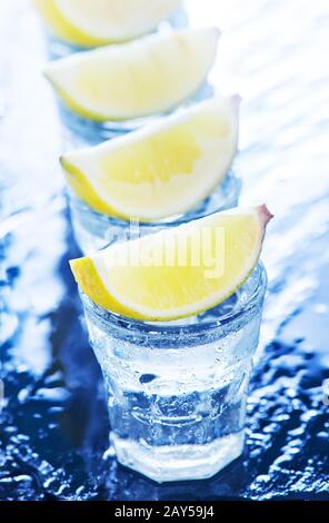 Tequilla con calce e su un tavolo Foto Stock