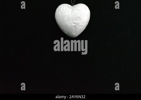 Un cuore bianco su un nero Foto Stock