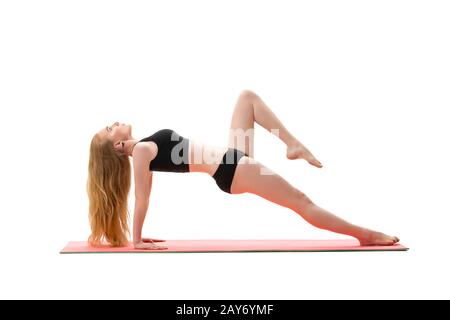 Slim blonde facendo handstand studio shot Foto Stock