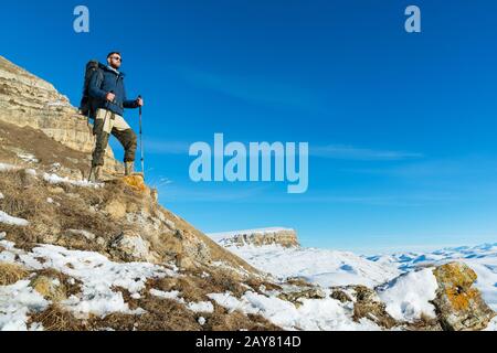 Un viaggiatore hippster con una barba che indossa occhiali da sole in natura. Foto Stock