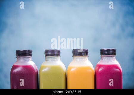 Frullati colorati in bottiglie di plastica Foto Stock