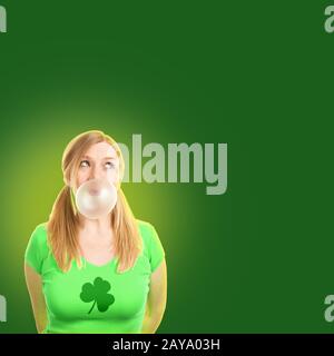 Donna che indossa il verde t-shirt con shamrock stampati su di essa celebra la festa di San Patrizio. Foto Stock