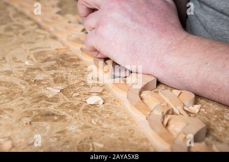 Scultori in legno crea un ornamento di mobili. Scultori in legno con le mani in mano, scalpelli, strumenti in legno intagliato ornamento. Foto Stock