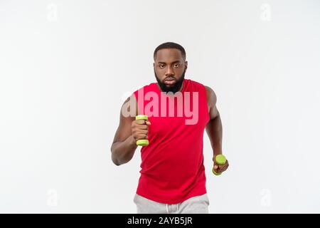 I giovani africani atleta americano tenendo il sollevamento pesi isolato su sfondo bianco. Foto Stock