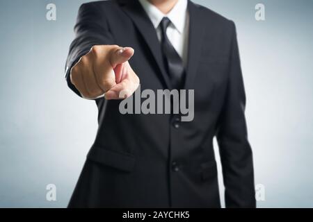 Business man punta il dito contro di te . (mettere a fuoco sulla mano Foto Stock
