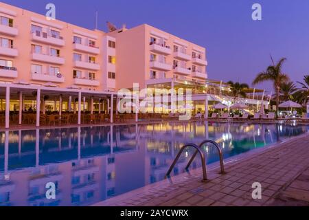 Piscina sull'isola di Cipro al tramonto Foto Stock