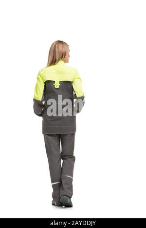 Bionda in abiti da lavoro isolato dietro la vista Foto Stock