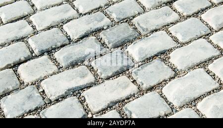 Strada pavimentata con ciottoli per il tuo sfondo Foto Stock