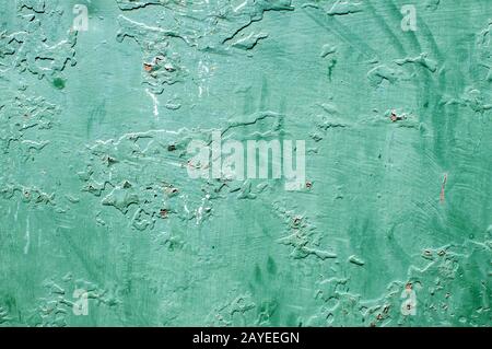Grunge weathered incrinato dipinto muro intonacato closeup come sfondo verde Foto Stock
