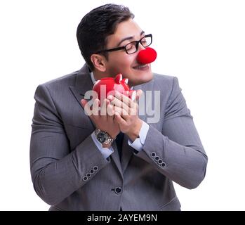 Funny clown imprenditore con un salvadanaio isolato sul retro bianco Foto Stock