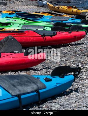 Akrotiri, Grecia - 19 luglio 2019: Un gruppo di canoe dai colori vivaci sulla spiaggia sassosa di Akrotiri Foto Stock