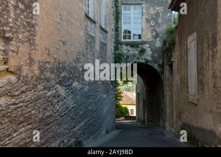 Una stretta porta di pietra nel borgo medievale di Goult nel Luberon, Provenza-Alpi-Costa Azzurra nella Francia meridionale. Foto Stock