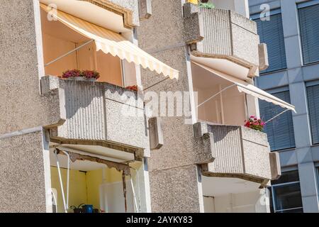 Ombrelloni e ombrelloni sui balconi di un alto edificio di appartamenti in Europa Foto Stock