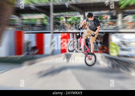 13 MAGGIO 2018, BUDAPEST, UNGHERIA: L'uomo esegue una stunt con bicicletta bmx alla rampa di uno skatepark nel parco cittadino Foto Stock