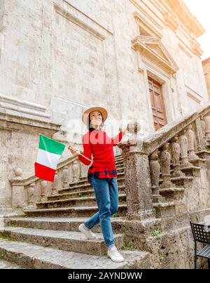 Donna viaggiatore con bandiera in strada stretta in Italia Foto Stock