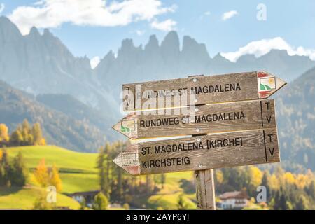 Cartello escursionistico, che indica diversi percorsi nella Val di Funes in Dolomiti Alpi montagne italiane Foto Stock