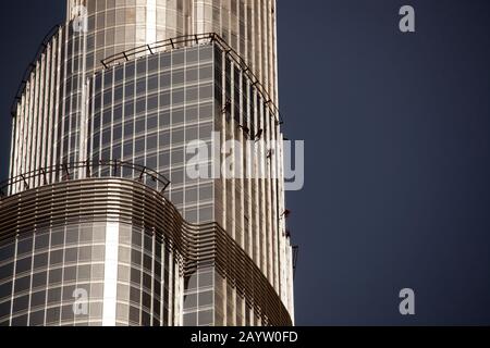 I pulitori delle finestre si abbassano verso l'esterno del Burj Khalifa, pulendolo in preparazione alla sua inaugurazione. Foto Stock