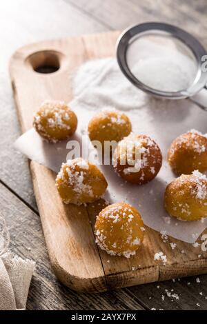 Frittelle di Carnevale o buñuelos de viento per la settimana Santa su tavola di legno Foto Stock