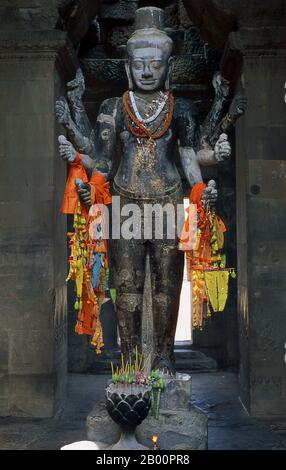 Cambogia: Una statua armata di Vishnu a Angkor Wat. Angkor Wat fu costruito per il re Suryavarman II (governato dal 1113 al 50) all'inizio del XII secolo come tempio di stato e capitale. Come il tempio meglio conservato del sito di Angkor, è l'unico ad essere rimasto un centro religioso significativo sin dalla sua fondazione - prima indù, dedicato al dio Vishnu, poi buddista. E' il più grande edificio religioso del mondo. Il tempio è in cima allo stile classico dell'architettura Khmer. È diventato un simbolo della Cambogia, che appare sulla sua bandiera nazionale. Foto Stock