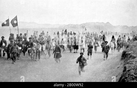 Cina: Uighur coscritti costretti nell'esercito tungano di ma Zhongying, Kumul (Hami), 1933. Notare le bandierine Kuomintang (KMT). La cricca ma è un nome collettivo per un gruppo di signori della guerra Hui (cinesi musulmani) nella Cina nordoccidentale che governarono le province cinesi di Qinghai, Gansu e Ningxia dagli anni '10 fino al 1949. Ci erano tre famiglie nella cricca di ma (‘MA’ essendo una rappresentazione comune di Hui del nome musulmano comune, Muhammad), ciascuna delle quali controllava una zona rispettivamente. I tre membri più prominenti della cricca erano ma Bufang, ma Hongkui e ma Hongbin. Foto Stock