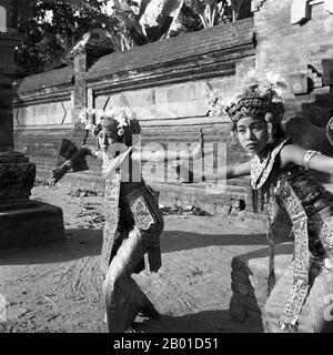 Indonesia: Due ballerini Legong in un tempio sull'isola di Bali, c. 1953. Foto di Paul Spies/Tropenmuseum (CC BY-SA 3,0 License). Legong è una forma di danza balinese. E' una forma di danza raffinata caratterizzata da intricati movimenti delle dita, complicate pedane, gesti espressivi ed espressioni facciali. Legong probabilmente ha avuto origine nel 19th ° secolo come intrattenimento reale. La leggenda narra che un principe di Sukwati si ammalò e ebbe un sogno vivido in cui due fanciulle danzavano alla musica gamelana. Quando si riprese, fece eseguire tali danze in realtà. Foto Stock