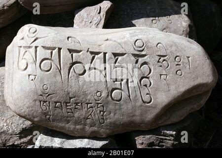 Cina/Tibet: Una pietra di mani buddista Mahayana con mantra in copione tibetana. Foto di Jolly Nomad (CC BY-SA 3,0 License), 2008. Le pietre mani sono lastre di pietra, rocce e/o ciottoli, inscritti con il mantra a sei sillaba di Avalokiteshvara (um mani padme hum, da cui il nome 'mani stone'), come una forma di preghiera nel buddismo tibetano. Il termine pietra mani può anche essere usato in un senso sciolto per riferirsi a pietre su cui qualsiasi mantra o disegni devozionali (come ashtamangala) sono inscritti. Le pietre mani sono disposte intenzionalmente lungo le strade e i fiumi o messe insieme per formare tumuli o cairns. Foto Stock