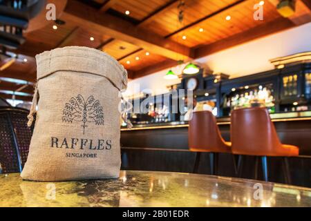 All'interno del famoso Raffles Long Bar, Singapore, che mostra una tradizionale borsa di arachidi con il nome Raffles su di esso, Singapore, Asia. Foto Stock