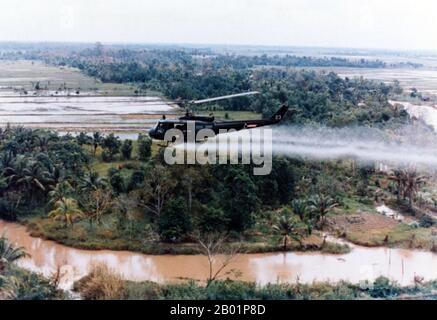 Vietnam: Un elicottero statunitense Huey spray agent Orange durante l'operazione Ranch Hand, c. 1963. L'operazione Ranch Hand fu un'operazione militare statunitense durante la guerra del Vietnam, che durò dal 1962 al 1971. Faceva parte del programma generale di guerra erbicidale durante la guerra chiamato "operazione Trail Dust". Ranch Hand ha coinvolto l'irrorazione di circa 20 milioni di galloni statunitensi di defolianti ed erbicidi sulle aree rurali del Vietnam del Sud nel tentativo di privare l'NLF (Viet Cong) di copertura vegetativa e cibo. Anche le aree del Laos e della Cambogia sono state spruzzate in misura minore. Foto Stock