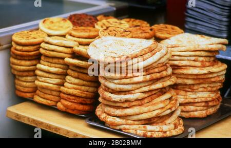 Cina: Selezione di pane piatto, Beiyuanmen, The Islamic Walking Street, Xi’an, Shaanxi Province. Dalla covata olandese, dal brot tedesco e dalla brea frisone, il pane inglese antico è un tipo di cibo popolare in tutto il mondo e vecchio come la civiltà organizzata. È il cibo di base in Europa e nelle culture influenzate dall'Europa nelle Americhe, in Africa e in Medio Oriente, in contrasto con l'importanza del riso nell'est e nel sud-est asiatico. XI'an è la capitale della provincia di Shaanxi e una città sub-provinciale della Repubblica Popolare Cinese. È una delle città più antiche della Cina. Foto Stock