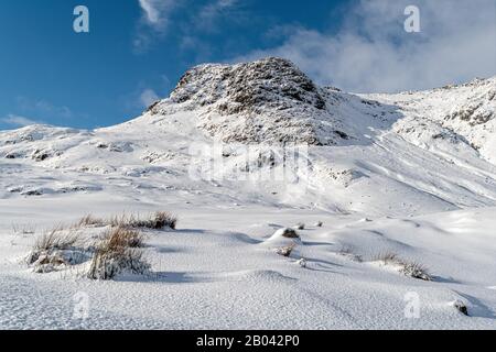 Un Harrison Stickle innevato visto da Stickle Tarn Foto Stock