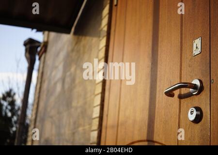 Facciata di una casa con una porta marrone e chiusa Foto Stock