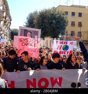 Una processione composta da molti giovani studenti che protestano contro il cambiamento climatico presentando cartelli e striscioni con messaggi. Foto Stock