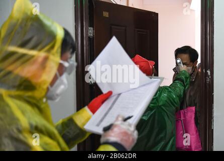 Pechino, La Provincia Cinese Di Hubei. 18th Feb, 2020. Un residente effettua il controllo della temperatura corporea durante una campagna di screening sanitario presso la Comunità di Qingheju nel distretto di Qingshan di Wuhan, capitale della provincia dell'Hubei nella Cina centrale, 18 febbraio 2020. Wuhan lancia una serie di misure di ampia portata e più rigorose dal 17to 19 febbraio per controllare l'epidemia. Credito: Cheng Min/Xinhua/Alamy Live News Foto Stock