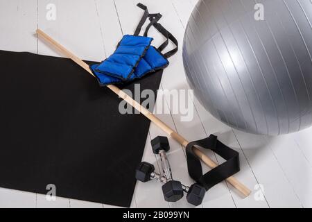 Attrezzature per l'allenamento - fitness, pesi, manubri, elastico, tappetino per lo yoga e bastone da palestra Foto Stock