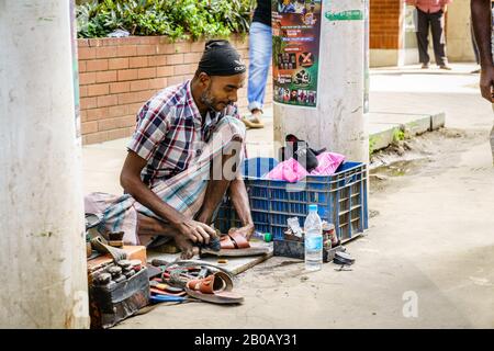 Chittagong, Bangladesh, 22 dicembre 2017: Servizio di riparazione scarpe su una strada di Chittagong in Bangladesh Foto Stock