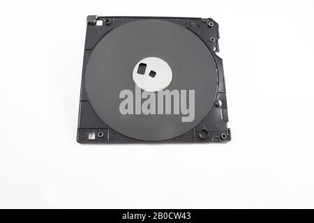 Aprire il vecchio disco floppy che mostra il supporto dati magnetico all'interno su sfondo bianco Foto Stock