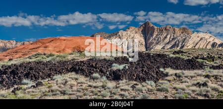 Rocce laviche, bianco e rosso di arenaria Navajo formazioni rocciose, Flusso di Lava Trail a Snow Canyon State Park, Utah, Stati Uniti d'America Foto Stock