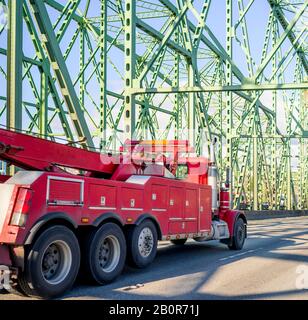 Motrice semi-motrice industriale diesel rosso mobile con braccio di sollevamento e luci di emergenza per il traino di grandi dimensioni e il trasporto per impieghi gravosi Foto Stock