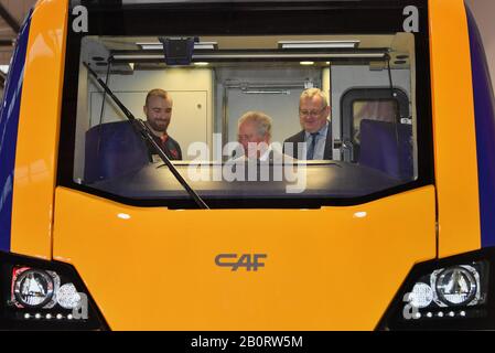 Il Principe di Galles, seduto al posto di guida di un treno costruito durante una visita alla fabbrica di treni CAF a Newport, Galles. Foto Stock