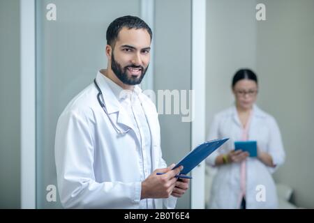 Medici maschi e femmine dai capelli scuri che si trovano nella stanza Foto Stock