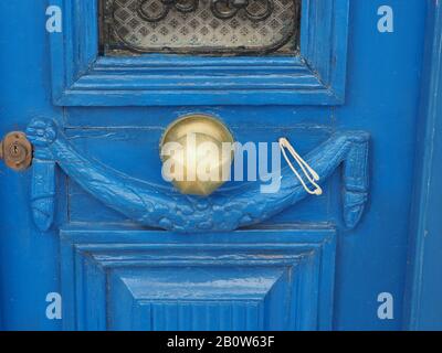 Vecchia porta in legno, intagliata, dipinta di blu con maniglia e serratura in ottone, a Citera, Grecia Foto Stock