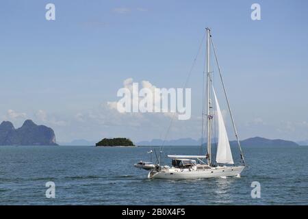 Barca a vela di fronte alle isole nella baia di Pang Nga, Thailandia meridionale, Sud-Est asiatico, Foto Stock