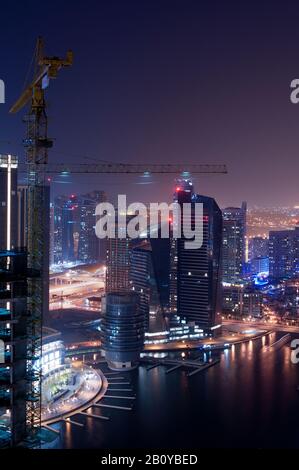 Gru da cantiere a Marina di notte, Dubai, Emirati Arabi Uniti, Foto Stock