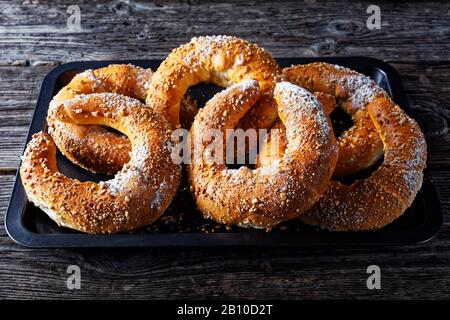 Involtini di pasticceria austriaca kifli di kipfel cosparsi di noci e zucchero a velo, servito su un vecchio fienile sfondo di legno, primo piano Foto Stock